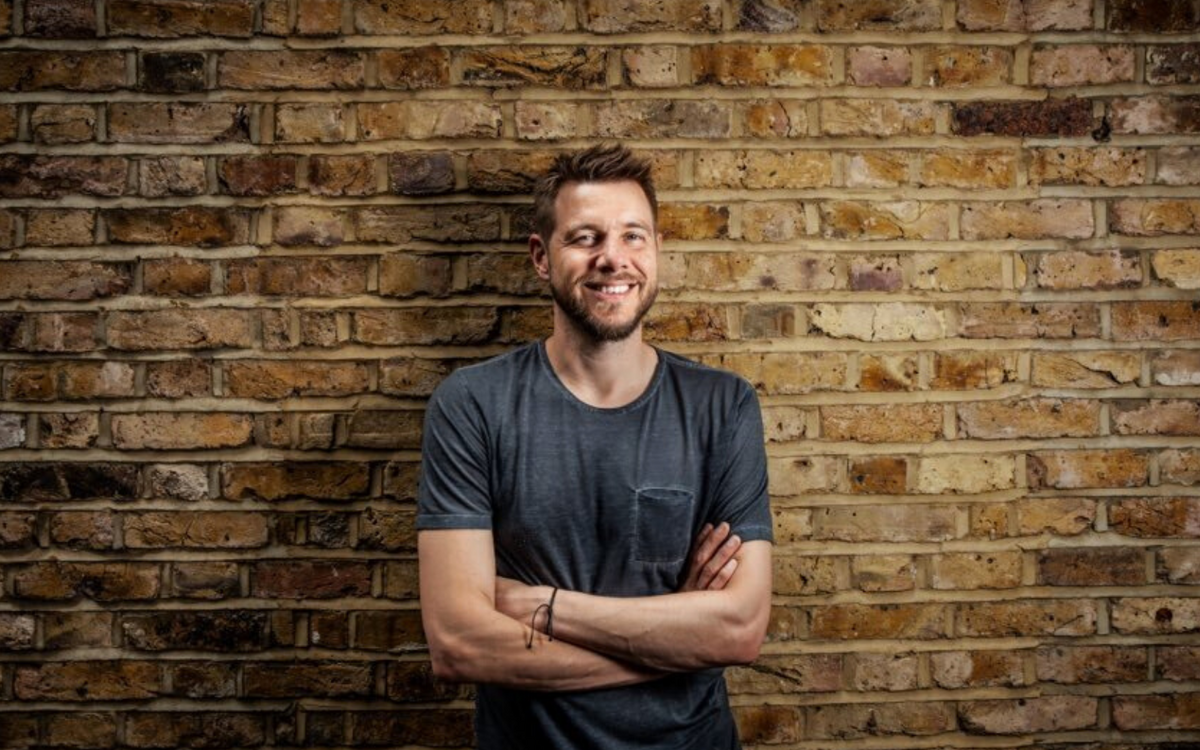 man up against a brick wall