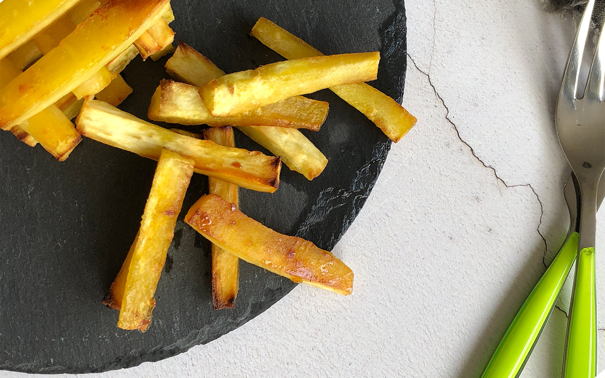 parsnips cooked in avocado oil on black slate