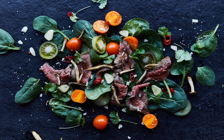steak and cherry tomatoes with salad leaves 