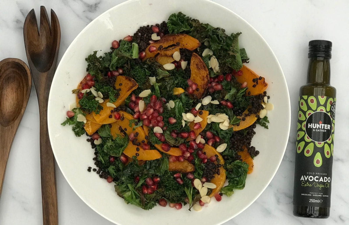 hot salad with wooden utensils and avocado oil
