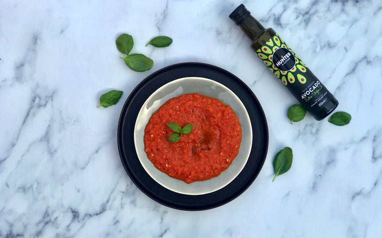 red sauce dip with basil leaves and avocado oil