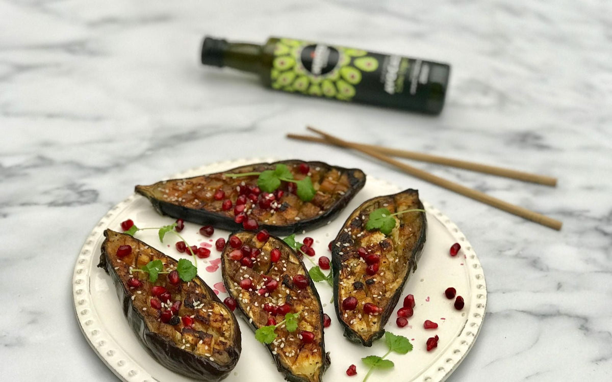 white plate with salad and pomegranate seeds with avocado oil