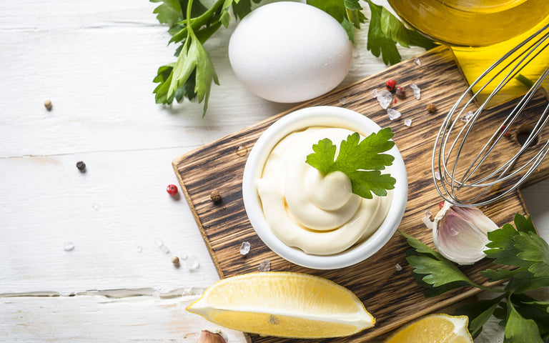olive oil mayonnaise: Mayonnaise in a small ramekin with eggs, lemons, herbs and spices