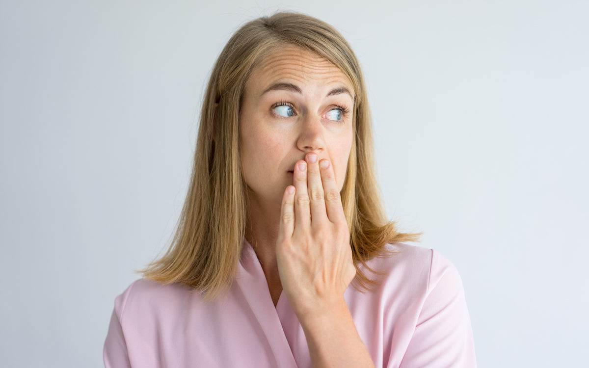 keto breath: woman covering her mouth
