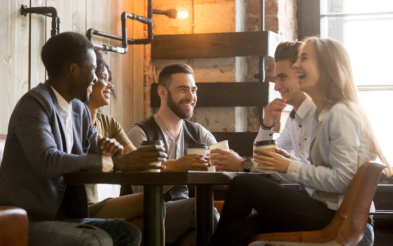 Gathering of people at a table having bulletproof coffee