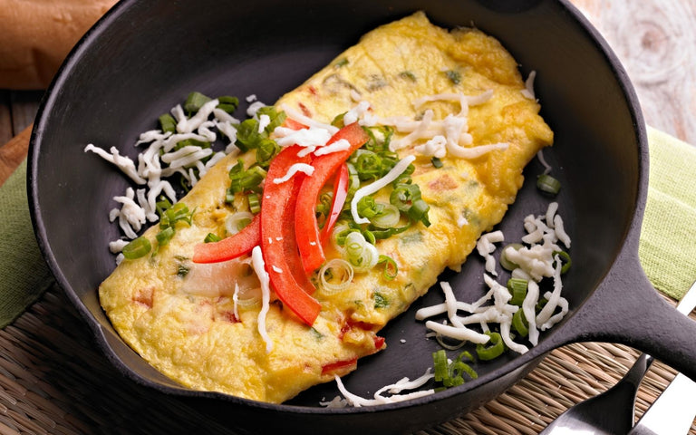 vegetarian keto diet: Stuffed egg omelette with vegetables on a plate