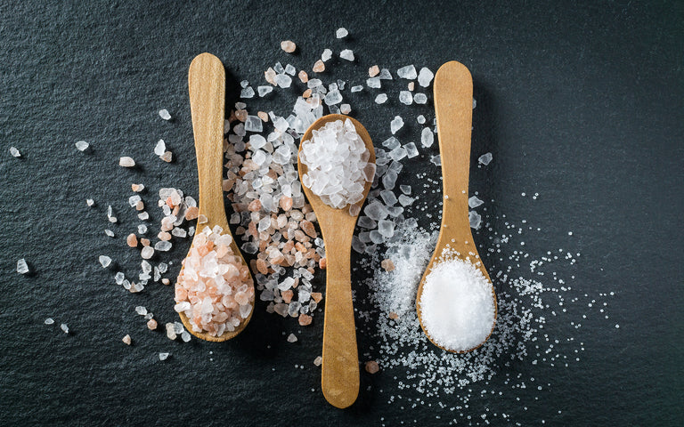 Three wooden spoons with salt 