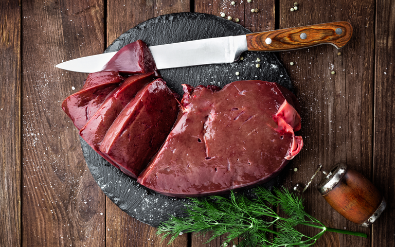 raw liver on slate and knife