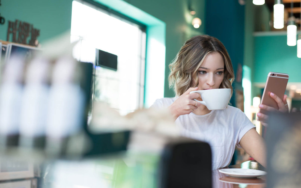 woman drinking bone broth in a coffee shop