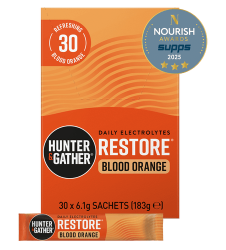 Orange packaging of Hunter & Gather Restore Blood Orange electrolyte supplement with branding and award badge.