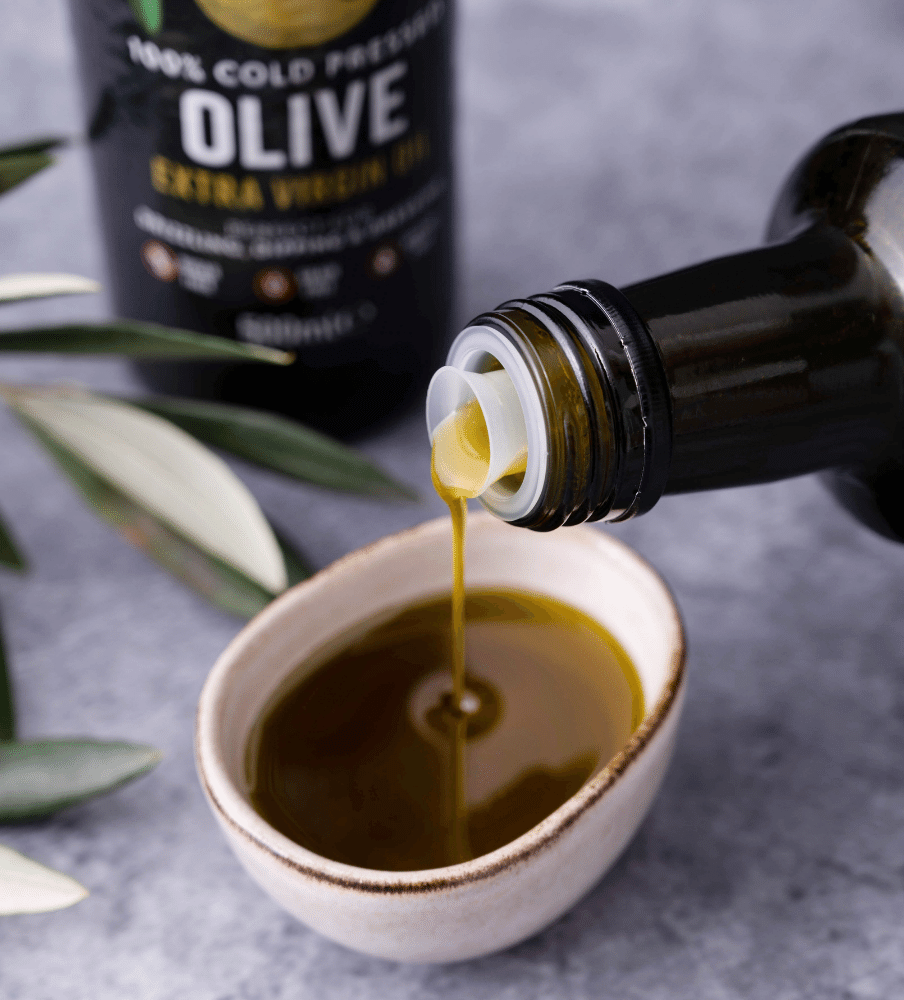 Organic Cold Pressed Extra Virgin Olive Oil Pouring Into Bowl